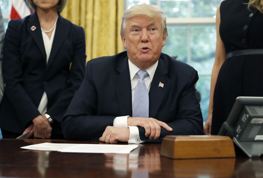 President Donald Trump speaks about Harvey in the Oval Office of the White House, Friday, Sept. 1, 2017, in Washington. (AP Photo/Alex Brandon)