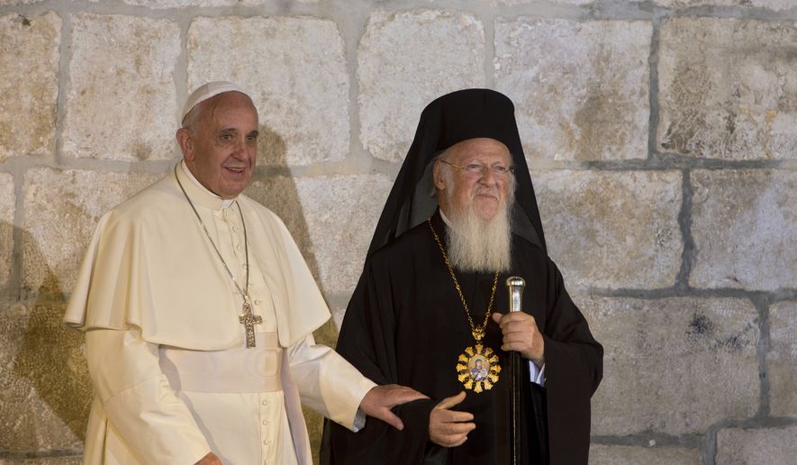 In this May 25, 2014, file photo, Pope Francis stands with Ecumenical Patriarch Bartholomew I as they meet outside the Church of the Holy Sepulchre, in Jerusalem's Old City. Pope Francis and the spiritual leader of the world's Orthodox Christians are urging political leaders to "support the consensus of the world" that climate change and other environmental ills have created an ecological crisis that is harming the world's poorest the most. Christianity's top spiritual leaders issued the joint appeal Friday, Sept. 1, 2017, which both Catholic and Orthodox churches mark as a day of prayer for God's creation. (AP Photo/Sebastian Scheiner, File)