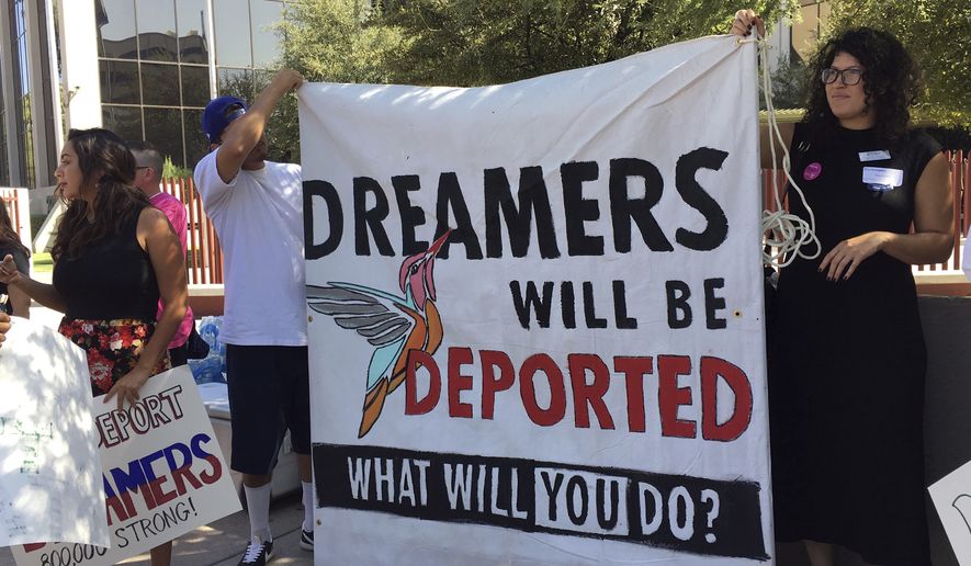 Immigrant rights groups, advocating for DACA, the program that allows youths who were brought to the country illegally as children to legally work and be shielded from deportation, rally in Phoenix, Ariz., Monday, Aug. 28, 2017. President Donald Trump is deciding whether to keep the program as Republican officials from 10 states have threatened to sue to stop the program, giving Trump a Sept. 5 deadline to act. (AP Photo/Astrid Galvan)