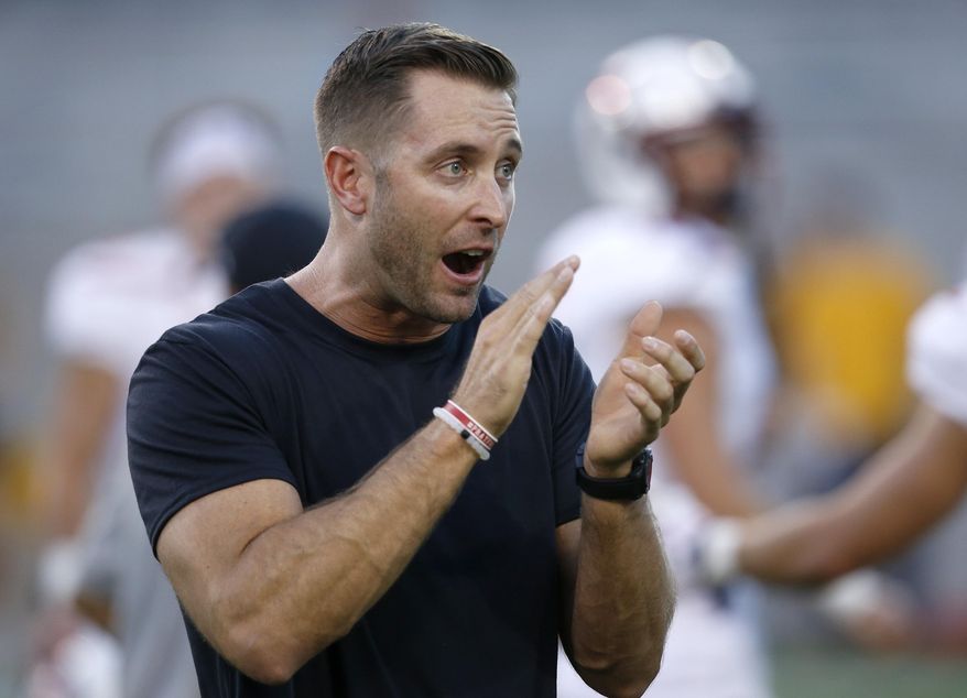 FILE - This Sept. 10, 2016, file photo shows Texas Tech head coach Kliff Kingsbury applauding as they warm up prior to an NCAA college football in Tempe, Ariz. Kingsbury’s fifth season begins at home Saturday against Eastern Washington, the FCS leader with 401 yards passing per game last season. (AP Photo/Ross D. Franklin, File)