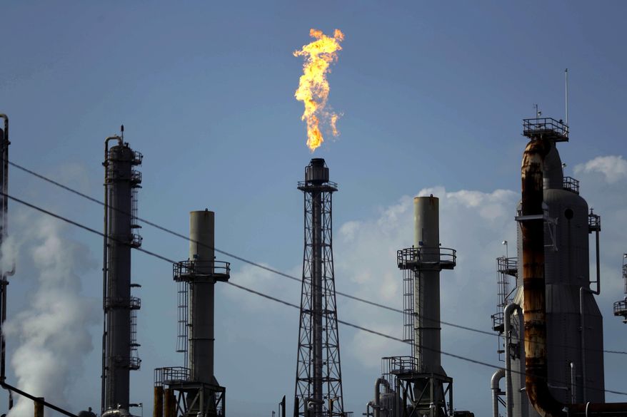 In this Thursday, Aug. 31, 2017, file photo, a flame burns at the Shell Deer Park oil refinery in Deer Park, Texas. Dry gas stations and panicked motorists are sending gasoline prices higher after Hurricane Harvey. (AP Photo/Gregory Bull, File)
