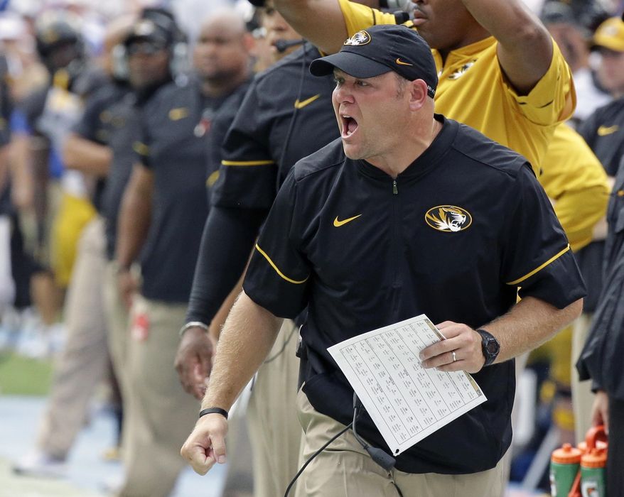 FILE - In this Oct. 15, 2016, file photo, Missouri head coach Barry Odom shouts encouragement to his players during the first half of an NCAA college football game against Florida, in Gainesville, Fla. The Tigers and Bears are each coming off of four-win seasons. For Missouri, 4-8 was a disappointing beginning to coach Barry Odom’s tenure. (AP Photo/John Raoux, File)