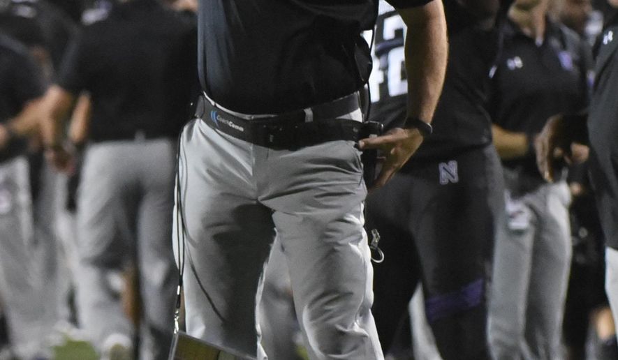 FILE - In this Sept. 24, 2016, file photo, Northwestern head coach Pat Fitzgerald yells from the sidelines during the first quarter of an NCAA college football game against Nebraska in Evanston, Ill. With more wins than any other Northwestern coach and two of the Wildcats’ three bowl victories, Pat Fitzgerald could call his tenure a success. Yet there’s something missing as he enters his 12th season _ first-place finishes. (AP Photo/Matt Marton, File)