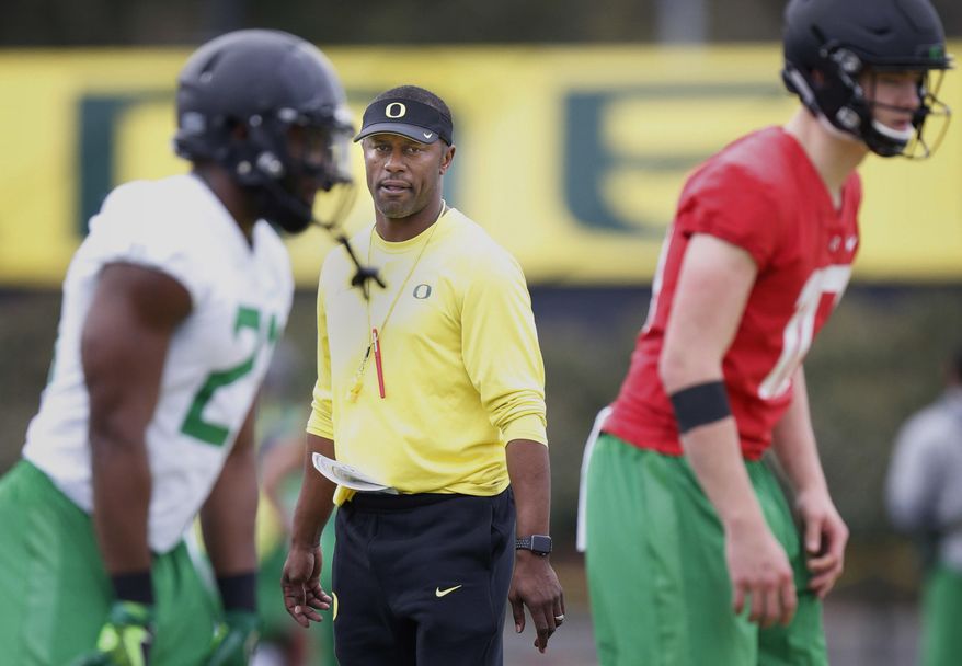 FILE - In this April 5,2017, file photo, Oregon's first year head coach Willie Taggart watches his running back Royce Freeman, left, and quarterback Justin Herbert as they run through a drill during the first day of spring practice for the Ducks in Eugene, Ore. The first-year coach and his Oregon Ducks open the season at home against Southern Utah on Saturday, Sept. 2, 2017, and Taggart admits he's a little bit nervous.(Andy Nelson/The Register-Guard via AP, File)