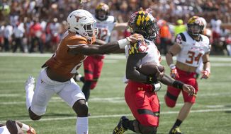 Maryland quarterback Tyrrell Pigrome, front right, eludes Texas&#39; Kris Boyd for a touchdown during second-quarter NCAA college football game action in Austin, Texas, Saturday, Sept. 2, 2017. (Ralph Barrera/Austin American-Statesman via AP)