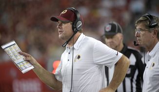 Washington Redskins head coach Jay Gruden, left, gives instructions from the sideline during the second half of an NFL preseason football game against the Tampa Bay Buccaneers Thursday, Aug. 31, 2017, in Tampa, Fla. The Redskins won 13-10. (AP Photo/Phelan M. Ebenhack)