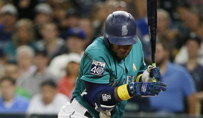 Seattle Mariners&#x27; Robinson Cano is hit by a pitch during the third inning of a baseball game against the Oakland Athletics, Friday, Sept. 1, 2017, in Seattle. (AP Photo/Ted S. Warren)