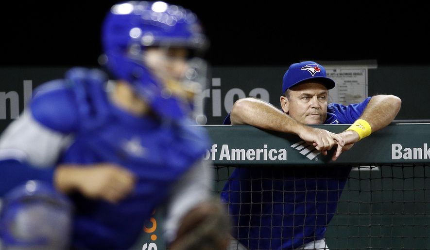 Toronto Blue Jays manager John Gibbons leans against the dugout rail beyond Blue Jays catcher Raffy Lopez during the third inning of a baseball game against the Baltimore Orioles in Baltimore, Friday, Sept. 1, 2017. Baltimore won 1-0 in 13 innings. (AP Photo/Patrick Semansky)