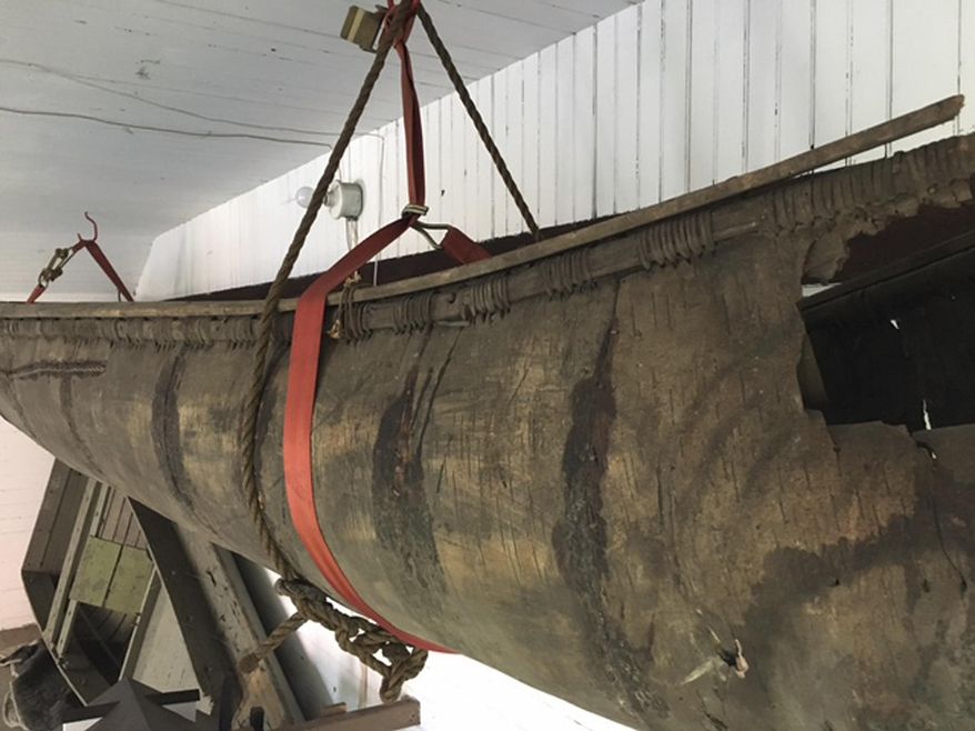 In a 2017 photo, a Wabanaki-made birch canoe that was carbon-dated to the 1700s is seen hanging in a barn behind the Pejepscot Historical Society museum in Brunswick, Maine. The canoe, possibly the oldest such canoe in existence, has been removed for conservation and will go on display inside the museum as early as this fall. (Pejepscot Historical Society/Larissa Vigue Picard via AP)