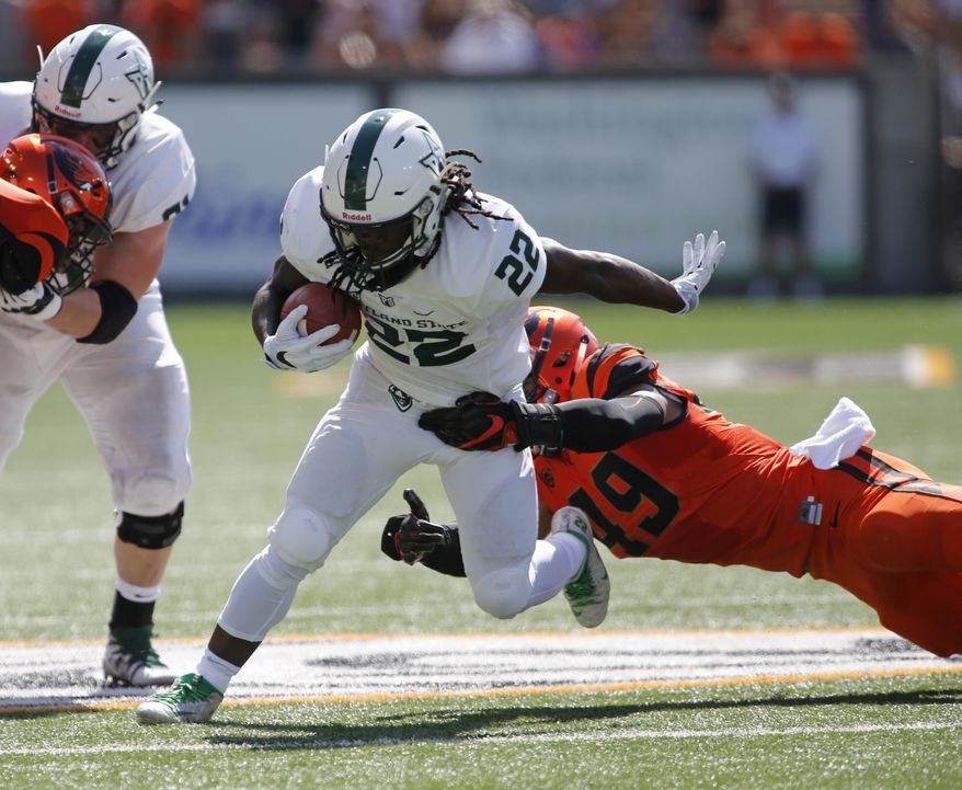 Portland State's Za'Quan Summers (22) sheds the tackle attempt by Oregon State's Andrzej Hughes-Murray (49) in the first half of an NCAA college football game, in Corvallis, Ore., Saturday, Sept. 2, 2017. (AP Photo/Timothy J. Gonzalez)