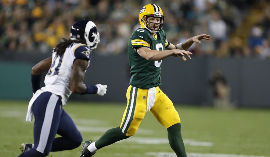 Green Bay Packers quarterback Taysom Hill throws past Los Angeles Rams' Marqui Christian during the second half of a preseason NFL football game Thursday, Aug. 31, 2017, in Green Bay, Wis. (AP Photo/Matt Ludtke)