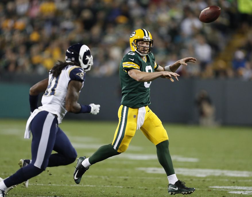 Green Bay Packers quarterback Taysom Hill throws past Los Angeles Rams' Marqui Christian during the second half of a preseason NFL football game Thursday, Aug. 31, 2017, in Green Bay, Wis. (AP Photo/Matt Ludtke)