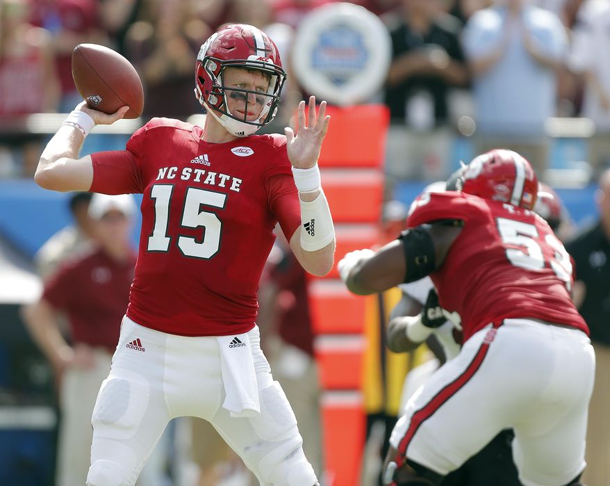 North Carolina State's Ryan Finley (15) aims a pass against the South Carolina defense during the first half of a college football game in Charlotte, N.C., Saturday, Sept. 2, 2017. (AP Photo/Bob Leverone)