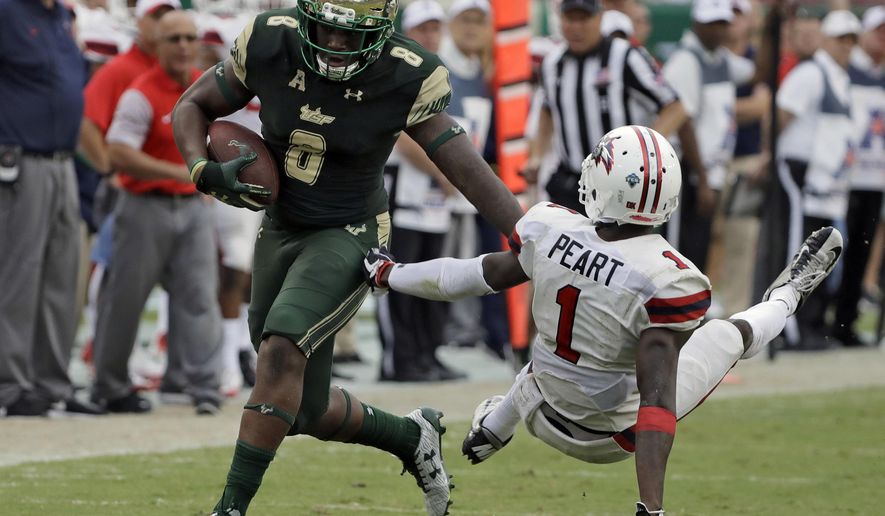 South Florida wide receiver Tyre McCants (8) pushes off Stony Brook defensive back Darin Peart (1) as he pulls in a 65-yard touchdown reception during the fourth quarter of an NCAA college football game Saturday, Sept. 2, 2017, in Tampa, Fla. (AP Photo/Chris O'Meara)