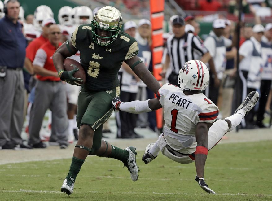 South Florida wide receiver Tyre McCants (8) pushes off Stony Brook defensive back Darin Peart (1) as he pulls in a 65-yard touchdown reception during the fourth quarter of an NCAA college football game Saturday, Sept. 2, 2017, in Tampa, Fla. (AP Photo/Chris O'Meara)