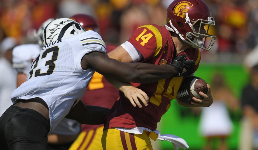 Southern California quarterback Sam Darnold, right, is sacked by Western Michigan defensive lineman Eric Assoua during the first half of an NCAA college football game, Saturday, Sept. 2, 2017, in Los Angeles. (AP Photo/Mark J. Terrill)