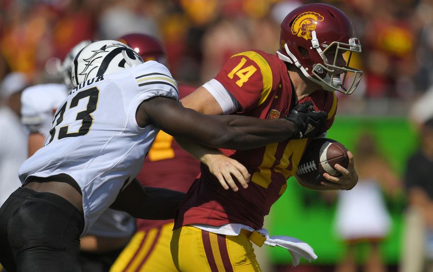 Southern California quarterback Sam Darnold, right, is sacked by Western Michigan defensive lineman Eric Assoua during the first half of an NCAA college football game, Saturday, Sept. 2, 2017, in Los Angeles. (AP Photo/Mark J. Terrill)