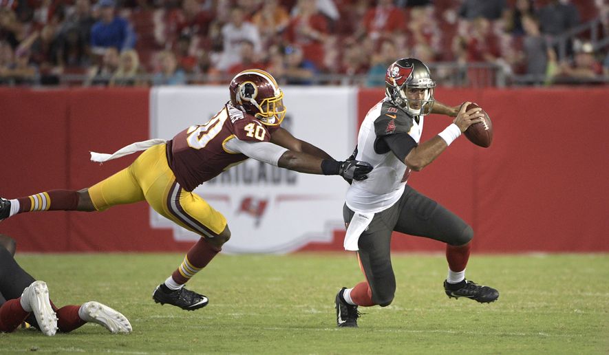 Tampa Bay Buccaneers quarterback Sefo Liufau (8), right, scrambles for yardage past Washington Redskins linebacker Josh Harvey-Clemons (40) during the second half of an NFL preseason football game Thursday, Aug. 31, 2017, in Tampa, Fla. The Redskins won 13-10. (AP Photo/Phelan M. Ebenhack)