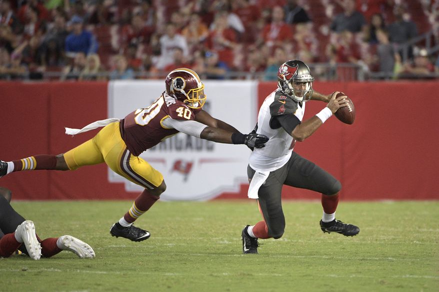 Tampa Bay Buccaneers quarterback Sefo Liufau (8), right, scrambles for yardage past Washington Redskins linebacker Josh Harvey-Clemons (40) during the second half of an NFL preseason football game Thursday, Aug. 31, 2017, in Tampa, Fla. The Redskins won 13-10. (AP Photo/Phelan M. Ebenhack)