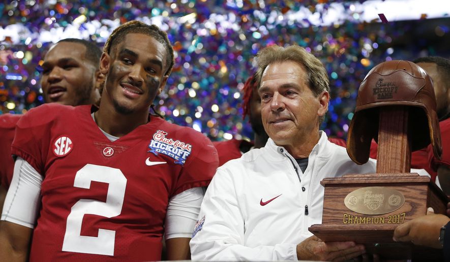 Alabama quarterback Jalen Hurts and Alabama head coach Nick Saban stand with the Leather Helmet trophy after an NCAA football game against Florida State, Saturday, Sept. 2, 2017, in Atlanta. Alabama won 24-7. (AP Photo/John Bazemore)