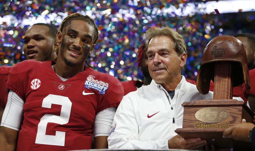 Alabama quarterback Jalen Hurts and Alabama head coach Nick Saban stand with the Leather Helmet trophy after an NCAA football game against Florida State, Saturday, Sept. 2, 2017, in Atlanta. Alabama won 24-7. (AP Photo/John Bazemore)