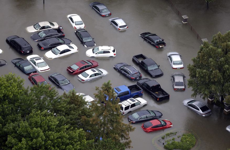 FILE - This Tuesday, Aug. 29, 2017, photo shows flooded cars near the Addicks Reservoir as floodwaters from Harvey rise in Houston. Auto industry experts estimate that 500,000 to 1 million cars, trucks and SUVs were damaged by floodwaters from Hurricane Harvey. Most will have so much water damage that they can’t be fixed, and insurance companies will declare them total losses. Yet the damaged cars could be retitled and sold to unsuspecting buyers nationwide. Experts warn against buying the cars because damage could be hidden for years before causing problems. (AP Photo/David J. Phillip, File)