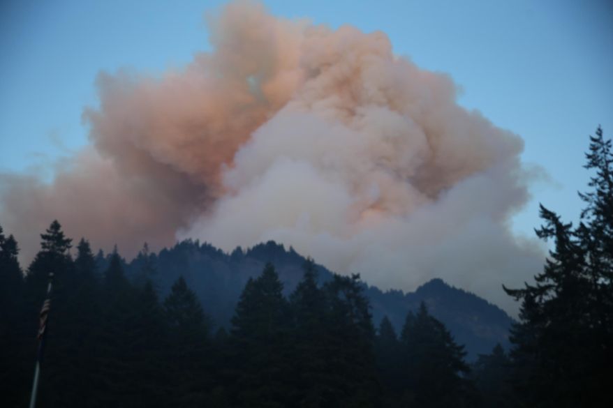 Fire burns in the Eagle Creek area of Columbia River Gorge, Saturday, Sept. 2, 2017. Officials reported that they had rescued six hikers Sunday morning, who were among about 140 forced to spend the night outside near Tunnel Falls after a fire broke out near the popular Columbia River Gorge trail about 90 miles east of Portland. (Mark Graves/The Oregonian via AP)