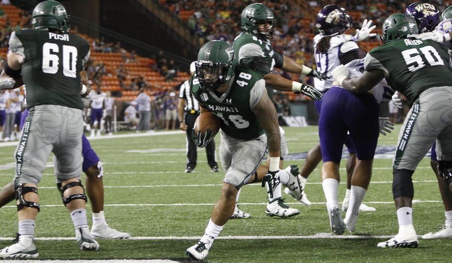 Hawaii running back Ryan Tuiasoa (48) runs in a touchdown against Western Carolina during the second quarter of an NCAA college football game, Saturday, Sept. 2, 2017, in Honolulu. (AP Photo/Marco Garcia)