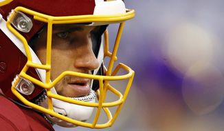 FILE - In this Aug. 10, 2017, file photo, Washington Redskins quarterback Kirk Cousins waits for a preseason NFL football game against the Baltimore Ravens in Baltimore. All I have to do, all anybody with a one-year deal has to do, is focus on winning football games, said Cousins, who threw for 25 touchdowns and a franchise-record 4,917 yards last season. If you do that, there is going to be plenty of opportunities down the road. (AP Photo/Patrick Semansk, File)