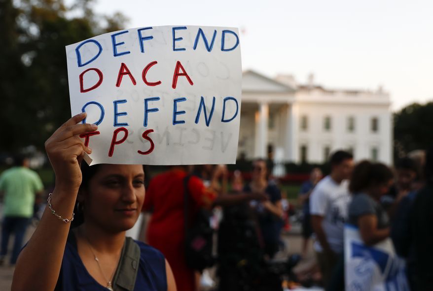 A woman holds up a sign that reads &quot;Defend DACA Defend TPS&quot; during a rally supporting Deferred Action for Childhood Arrivals, or DACA, outside the White House in Washington, Monday, Sept. 4, 2017. TPS stands for &quot;Temporary Protected Status.&quot; A plan President Donald Trump is expected to announce Tuesday for young immigrants brought to the country illegally as children was embraced by some top Republicans on Monday and denounced by others as the beginning of a &quot;civil war&quot; within the party. (AP Photo/Carolyn Kaster)