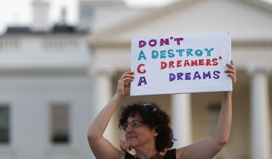 Julia Paley, of Arlington, Va., with the DMV Sanctuary Congregation Network, holds up a sign that reads &quot;DACA Don&#39;t Destroy Dreamers Dreams&quot; during a rally supporting Deferred Action for Childhood Arrivals, or DACA, outside the White House, in Washington on Sept. 4, 2017. (Associated Press) **FILE**