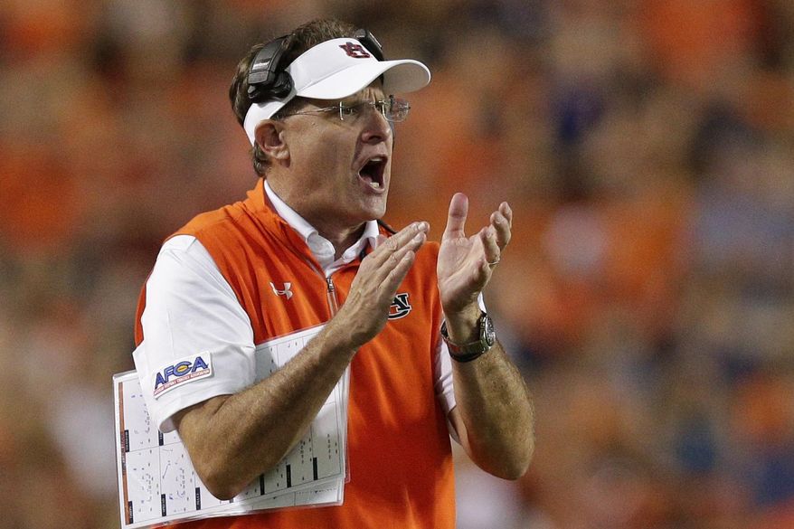 Auburn head coach Gus Malzahn claps to get his players attention in the second half of an NCAA college football game against Georgia Southern, Saturday, Sept. 2, 2017, in Auburn, Ala. Auburn won 41-7. (AP Photo/Brynn Anderson)