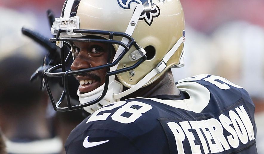 FILE - In this Aug. 10, 2017, file photo, file photo, New Orleans Saints running back Adrian Peterson stands on the sideline during warm ups before an NFL preseason football game against the Cleveland Browns, in Cleveland. The Saints open their season on Sept. 11 against Minnesota. (AP Photo/Ron Schwane, File)