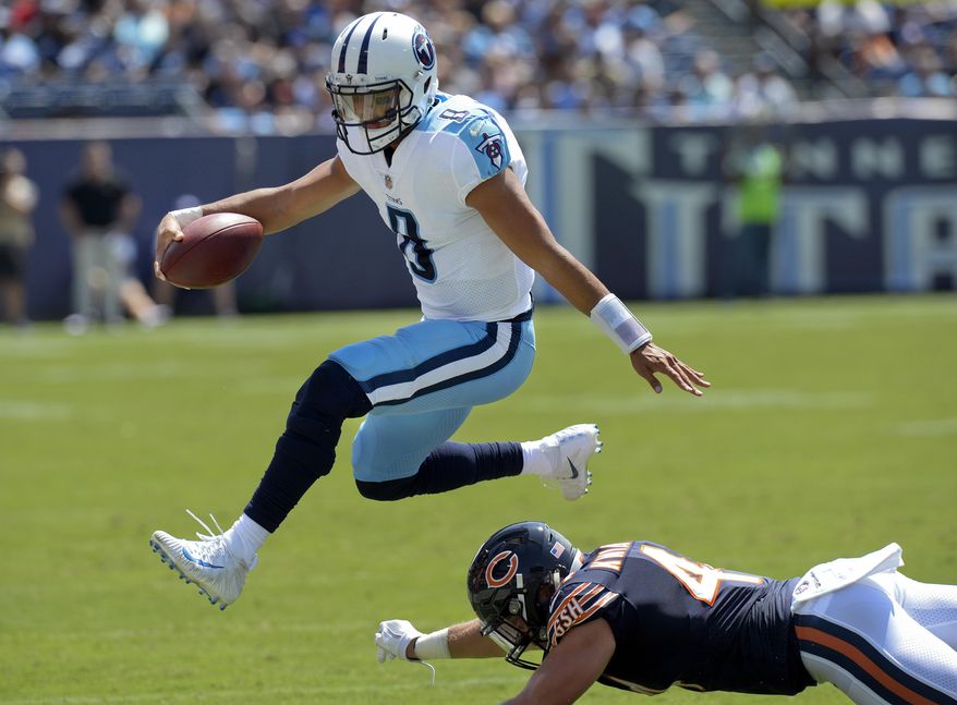 FILE - In this Aug. 27, 2017, file photo, Tennessee Titans quarterback Marcus Mariota (8) leaps over Chicago Bears inside linebacker Nick Kwiatkoski (44) in the first half of an NFL football preseason game, in Nashville, Tenn. As much as the Titans start their offense with the run, quarterback Marcus Mariota now has a lot more options when it comes to throwing downfield. (AP Photo/Mark Zaleski, File)