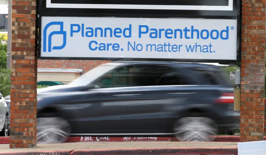 Traffic passes a Planned Parenthood sign in Dallas on June 27, 2016. (Associated Press) **FILE**