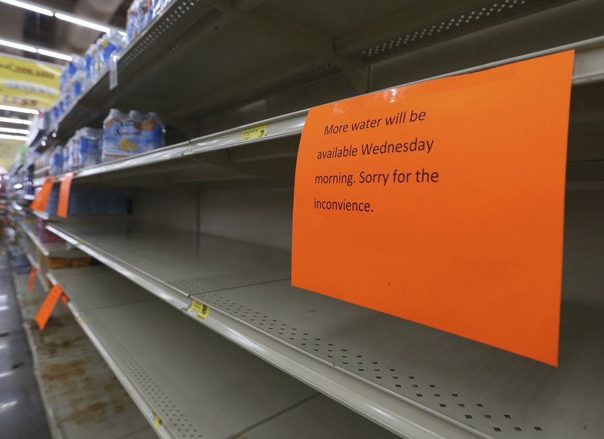 A shelf normally containing packaged water is empty at a Piggly Wiggly store Tueday, Sept. 5, 2017, in Panama City, Fla. Store managers informed shoppers that more water will be delivered on Sept.6 in the morning a residents prepare for Hurricane Irma. (patti Blake/News Herald via AP)