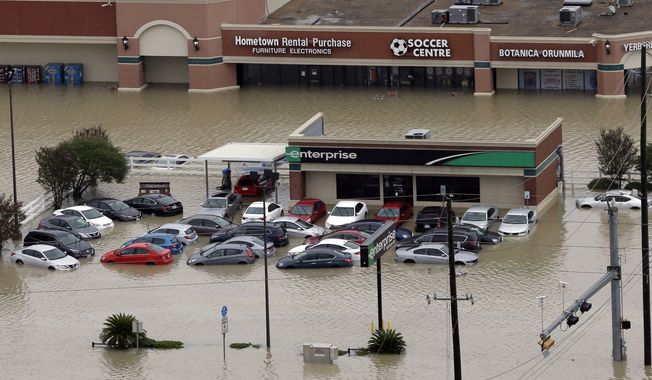 FILE - In this Aug. 29, 2017, file photo, cars are flooded near the Addicks Reservoir as floodwaters from Tropical Storm Harvey rise in Houston. Tens of thousands of personal vehicles were inundated by floodwaters or smashed by wind-tossed objects, creating a huge demand for rentals that has put the cars in painfully short supply in the Houston area and across eastern Texas. Rental companies say they are bringing in more vehicles from areas including the Southeast, but the logistics problems left by Harvey could get worse as Hurricane Irma threatens Florida. (AP Photo/David J. Phillip, File)