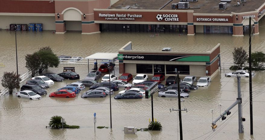 FILE - In this Aug. 29, 2017, file photo, cars are flooded near the Addicks Reservoir as floodwaters from Tropical Storm Harvey rise in Houston. Tens of thousands of personal vehicles were inundated by floodwaters or smashed by wind-tossed objects, creating a huge demand for rentals that has put the cars in painfully short supply in the Houston area and across eastern Texas. Rental companies say they are bringing in more vehicles from areas including the Southeast, but the logistics problems left by Harvey could get worse as Hurricane Irma threatens Florida. (AP Photo/David J. Phillip, File)