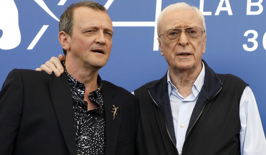 Director David Batty, left, and actor Michael Caine pose for photographers during the photo call of the film 'My Generation', at the 74th edition of the Venice Film Festival, in Venice, Italy, Tuesday, Sept. 5, 2017. (AP Photo/Domenico Stinellis)