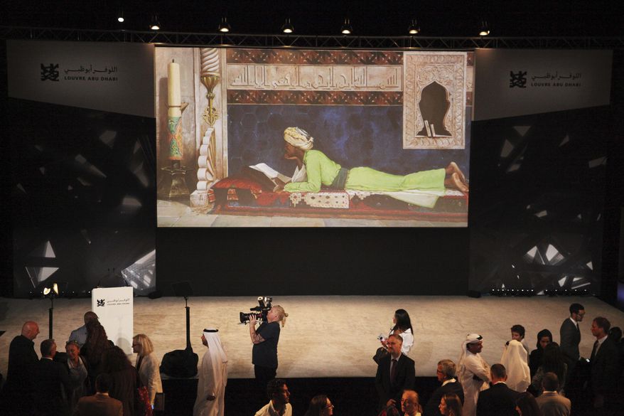 Journalists gather after an announcement about the opening of the Louvre Abu Dhabi in Abu Dhabi, United Arab Emirates, Wednesday, Sept. 6, 2017. Officials on Wednesday announced that the Louvre Abu Dhabi, a Mideast outpost of the famed French museum, will open Nov. 11. (AP Photo/Jon Gambrell)