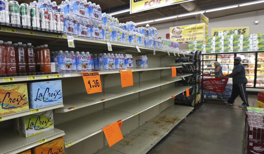A shelf normally containing packaged water sits empty at a Piggly Wiggly store Tueday, Sept. 5, 2017, in Panama City, Fla. Store managers informed shoppers that more water will be delivered on Sept.6 in the morning a residents prepare for Hurricane Irma. (Patti Blake/News Herald via AP)