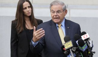 While his daughter Alicia Menendez looks on, Sen. Bob Menendez talk to reporters as he arrives to court for his federal corruption trial in Newark, N.J., Wednesday, Sept. 6, 2017.  The trial will examine whether he lobbied for Florida ophthalmologist Dr. Salomon Melgen&#x27;s business interests in exchange for political donations and gifts. Both have pleaded not guilty.(AP Photo/Seth Wenig)