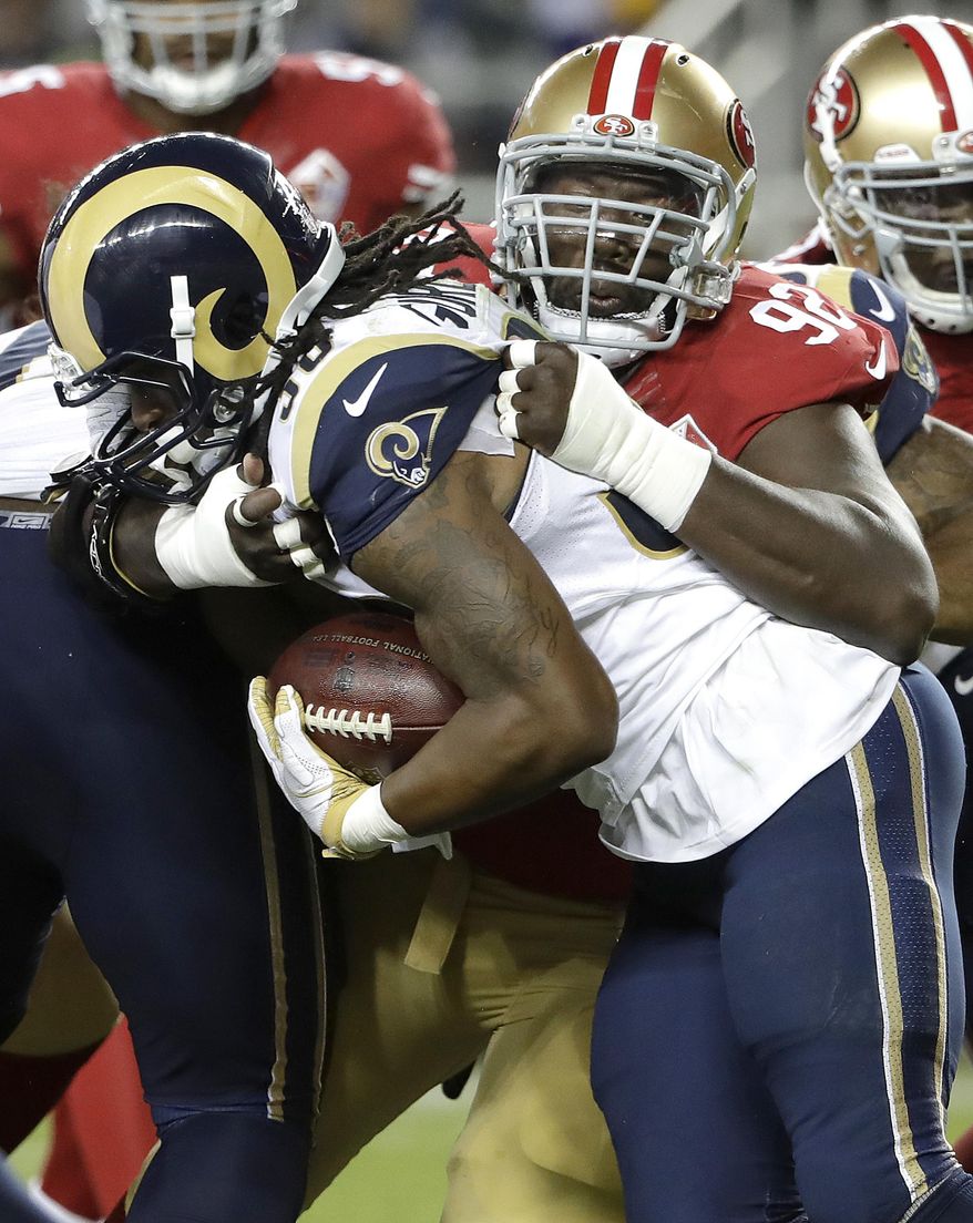 File- This Sept. 12, 2017, file photo shows San Francisco 49ers defensive end Quinton Dial (92) tackling Los Angeles Rams running back Todd Gurley during the first half of an NFL football game in Santa Clara, Calif. So many new veterans for the Green Bay Packers. At their core, the Packers still build through the draft. But general manager Ted Thompson has been more active than usual this season in signing veteran free agents. Dial, a 6-foot-5, 318-pound defensive lineman who signed on Tuesday, Sept. 5, 2017, after being released by the San Francisco 49ers. (AP Photo/Marcio Jose Sanchez, File)