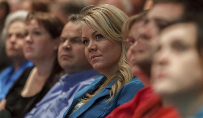 FILE - In this Nov. 30, 2012, file photo, Elissa Wall attends a community meeting regarding the United Effort Plan (UEP) trust, in Colorado City, Ariz. Wall who was married to her cousin at age 14 in a ceremony overseen by polygamous sect leader Warren Jeffs has won a $16 million lawsuit against the group. Wall's lawyer said Wednesday, Sept. 6, 2017, that the decision lets attorneys investigate the secretive group's bank accounts and property held in states all over the U.S.(Trent Nelson/The Salt Lake Tribune via AP, File)