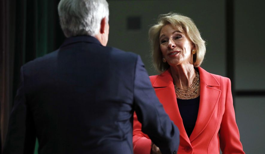 Henry Butler, dean of the Antonin Scalia Law School at George Mason University, greeted Betsy DeVos on Thursday before the secretary of education announced &quot;The era of &#39;rule by letter&#39; is over.&quot; (Associated Press) 