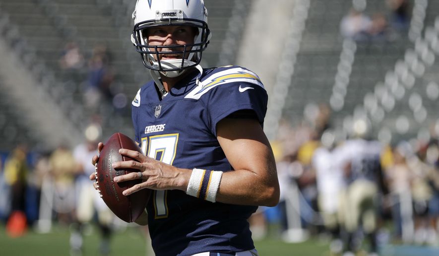FILE - In this Aug. 20, 2017, file photo, Los Angeles Chargers quarterback Philip Rivers warms up before an NFL preseason football game against the New Orleans Saints in Carson, Calif. Rivers is commuting from his family’s home in San Diego to the Chargers’ new training complex in a $200,000 RV this season. Even though he didn't move his wife and eight children north when the Chargers relocated, the veteran quarterback is eager to lead the Chargers' rebound when he begins his 12th season as their starter. (AP Photo/Jae C. Hong, File)