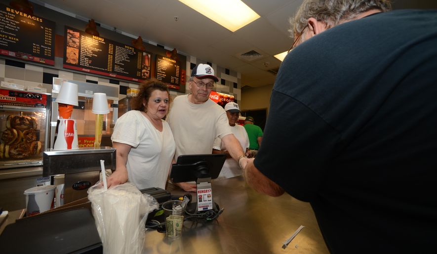 ADVANCE FOR WEEKEND EDITIONS, SEPT. 9-10 - In this Aug. 23, 2017 photo, members of Family Promise of Lehigh County took four hour shifts in Allentown, Pa., at Coca-Cola Park concession stands to raise money for their organization, which helps homeless families. (Chris Shipley/The Morning Call via AP)