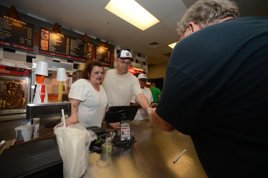 ADVANCE FOR WEEKEND EDITIONS, SEPT. 9-10 - In this Aug. 23, 2017 photo, members of Family Promise of Lehigh County took four hour shifts in Allentown, Pa., at Coca-Cola Park concession stands to raise money for their organization, which helps homeless families. (Chris Shipley/The Morning Call via AP)