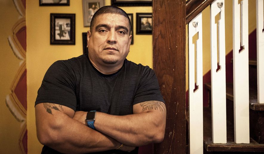 In this Sept. 1, 2017, photo, Sammy Rangel poses for a photo at his home in Racine, Wis. Rangel recently became the executive director of Life After Hate, a nonprofit that does work to rehabilitate former white supremacists. (Jack Zellweger/The Journal Times via AP)