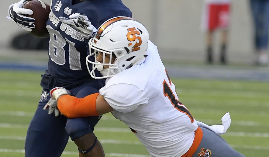 Utah State wide receiver Savon Scarver (81) is tackled by Idaho State defensive back Adkin Aguirre (12) during an NCAA football game Thursday, Sept. 7, 2017, in Logan, Utah. (Eli Lucero/Herald Journal via AP)